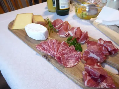 a cutting board with meat and cheese on a table at 22 – Zimmer & Zmorge in Kreuzlingen
