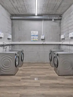 a laundry room with two washing machines in it at MOOI Apartments St.Gallen in St. Gallen