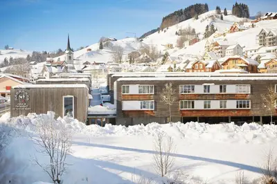 a city covered in snow with a building at Reka-Feriendorf Urnäsch in Urnäsch