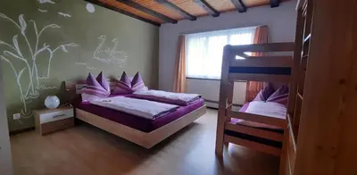 a bedroom with two bunk beds and a window at Ferienwohnung Schafbergblick in Wildhaus