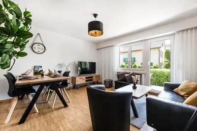 a living room with a table and a dining room at SOHO 12 !Gratis Parken, Free Parking! in Kreuzlingen