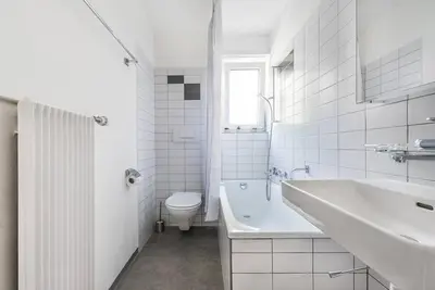a white bathroom with a sink and a toilet at SOHO 12 !Gratis Parken, Free Parking! in Kreuzlingen
