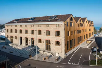 a large brick building next to a harbor at Business Appartement 3 am Bodensee in Romanshorn