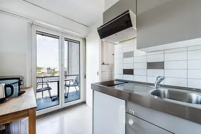 a kitchen with a sink and a view of a balcony at SOHO 6 !Gratis Parken, Free Parking! in Kreuzlingen