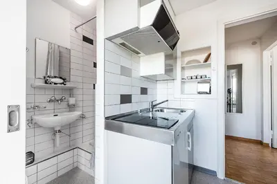 a white bathroom with a sink and a mirror at SOHO 6 !Gratis Parken, Free Parking! in Kreuzlingen