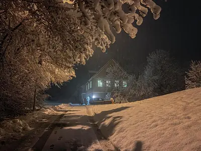 a house on a snow covered road at night at Ferienwohnung im Grünen in Altstätten