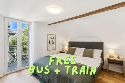 a bedroom with a bed with a free bus and train sign on it at Klara 1031 - Olma, Spital, Uni St- Gallen in St. Gallen