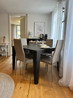 a dining room with a black table and chairs at Klara 1031 - Olma, Spital, Uni St- Gallen in St. Gallen