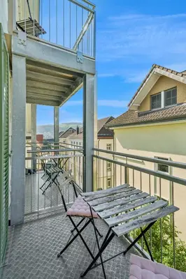 a balcony with two chairs and a table at Klara 1031 - Olma, Spital, Uni St- Gallen in St. Gallen