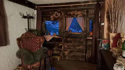 a living room with a chair and a window at IB Säntis Chalet Chnorz Entire House in Nesslau