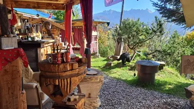 a log cabin with a table and a gorilla in the background at IB Säntis Chalet Chnorz Entire House in Nesslau