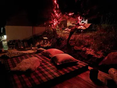 a large bed with pillows on a plaid blanket at IB Säntis Chalet Chnorz Apartment in Nesslau