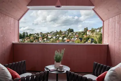 a room with a large window with a table and chairs at Dorfhus Gupf in Rehetobel