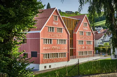 a group of red buildings in a city at Dorfhus Gupf in Rehetobel