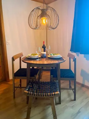 a table with plates of food and a bottle of wine at Ferienwohnung in Stein AR in Stein