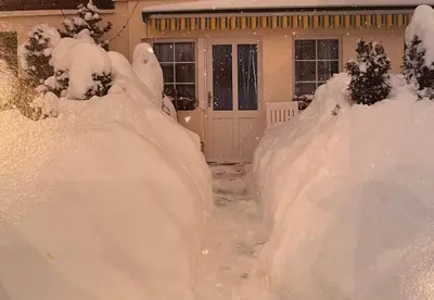 a yard covered in snow in front of a house at Ferienwohnung in Stein AR in Stein