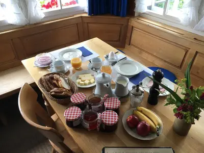 a wooden table with breakfast foods on it at Hirschen Wald - Gasthaus & Bäckerei in Wald