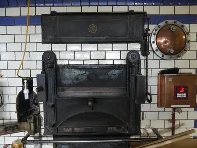an old stove is hanging on a wall at Hirschen Wald - Gasthaus & Bäckerei in Wald