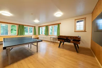a large room with a ping pong table in it at Ferienheim Bodenweidli in Wildhaus