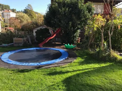 a small pool in a yard with a playground at Bijou 1 Hübsche 1 Zimmer Wohnung in Herisau