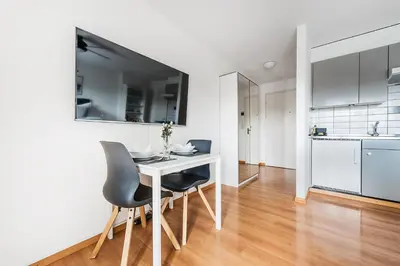 a kitchen and dining room with a white table and chairs at SOHO 3B !Gratis Parken, Free Parking! in Kreuzlingen