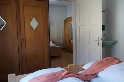 a bedroom with a bed and a hallway with a mirror at Villa Donkey BnB in Degersheim