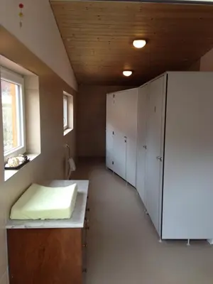 a room with white cabinets and a bed in it at Villa Donkey Chalet in Degersheim