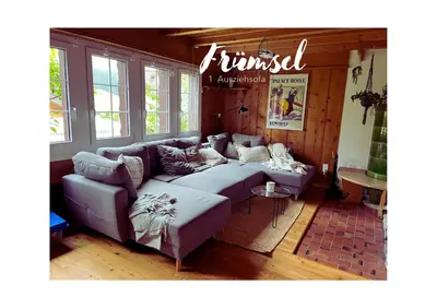 a living room with a couch in a room at Chalet Müsli in Wildhaus