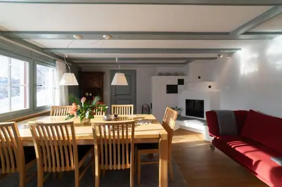 a living room with a table and a couch at Undereggli in Nesslau