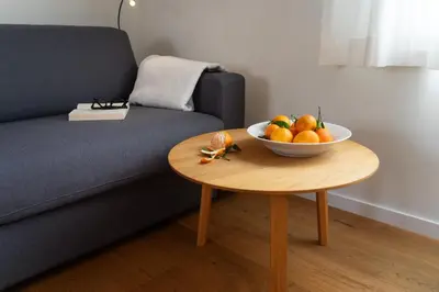 a bowl of fruit on a table next to a couch at Undereggli in Nesslau