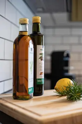 two bottles of honey sitting on a cutting board at Dein Zuhause in Herisau in Herisau