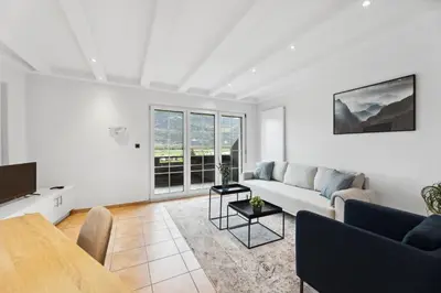 a living room with a couch and a table at Sonniges Apartment mit traumhaftem Bergblick in Buchs
