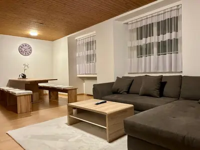 a living room with a couch and a table at tas24ch Travel and Sleep 24 in St. Gallen