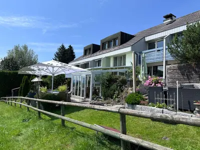 a house with a fence in front of it at Hotel Säntis Teufen in Teufen