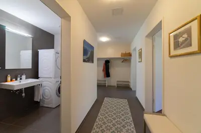a bathroom with a sink and a washing machine at Rietgarten in Wildhaus