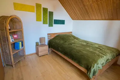 a bedroom with a bed and a book shelf at Naturoase Säntisblick-Auszeit am Wald und Bach in Kradolf