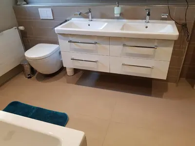 a bathroom with a white sink and a toilet at Ahornwohnung, ruhige Lage, nähe Bahnhof und Zentrum in Buchs