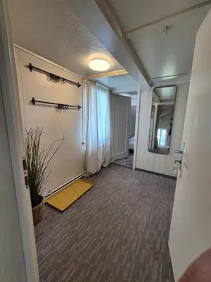 an empty room with a hallway with a potted plant at Villa Donkey Ferienwohnung in Degersheim