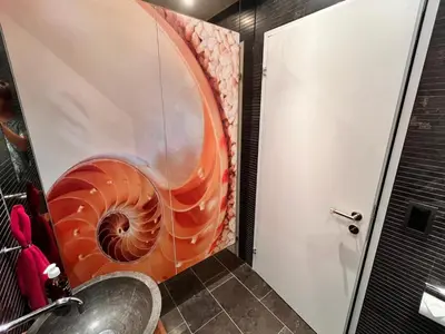 a bathroom with an orange spiral staircase next to a door at Deluxe Zimmer in Privatwohnung an zentraler Lage in Teufen