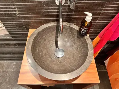 a sink with a soap bottle on top of it at Deluxe Zimmer in Privatwohnung an zentraler Lage in Teufen