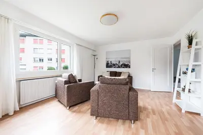 a living room with two chairs and a couch at SOHO 13 !Gratis Parken, Free Parking! in Kreuzlingen