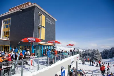 a group of people standing outside of a ski lodge at Berggasthaus Oberdorf in Wildhaus