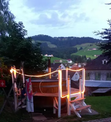 a wooden boat with lights in a yard at Pilger-Hüttli - Blockhaus in Schönengrund