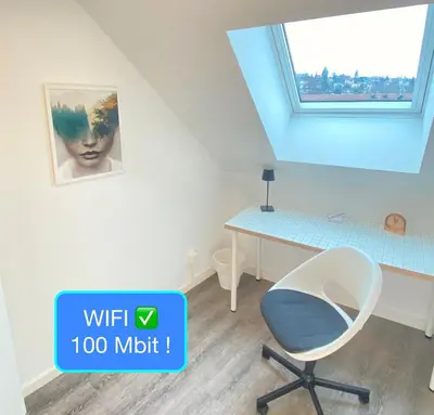 a room with a desk and a chair at Ruhige, neue Dachwohnung an Altstadt, nähe Messe in St. Gallen