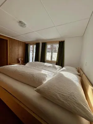 a bedroom with two beds and a window at Gasthof Ochsen in Nesslau