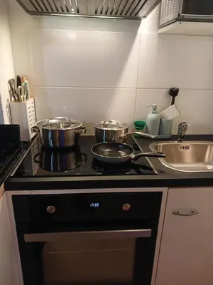 a kitchen with pots and pans on a stove at Ferienwohnung in Bühler nähe Appenzell in Bühler