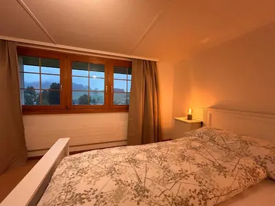 a bedroom with a bed and a window at Ferienwohnung mit Aussicht in Gais