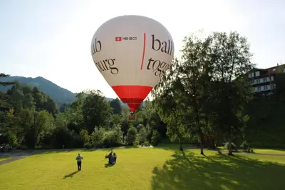 a hot air balloon is flying over a field at Hotel-Restaurant Sternen in Nesslau