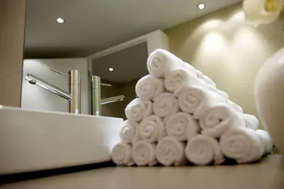 a pile of towels on a counter in a bathroom at Anker Hotel Restaurant in Teufen
