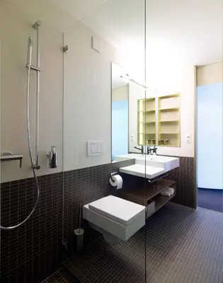 a bathroom with a toilet and a sink and a shower at Anker Hotel Restaurant in Teufen